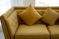 close-up-of-a-large-comfortable-sofa-with-mustard-2023-11-27-05-23-12-utc